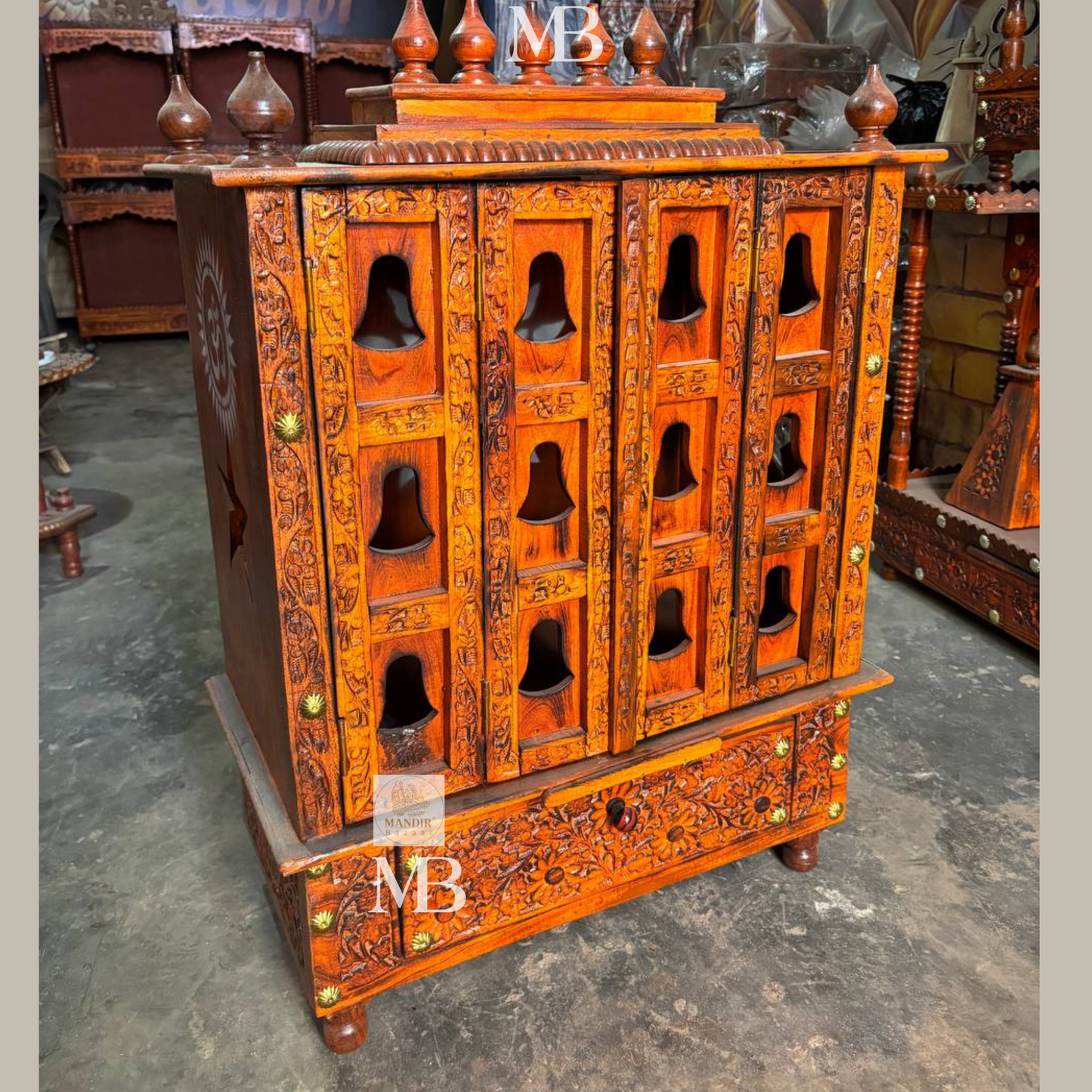 Traditional wooden pooja mandir with carved panels and decorative top