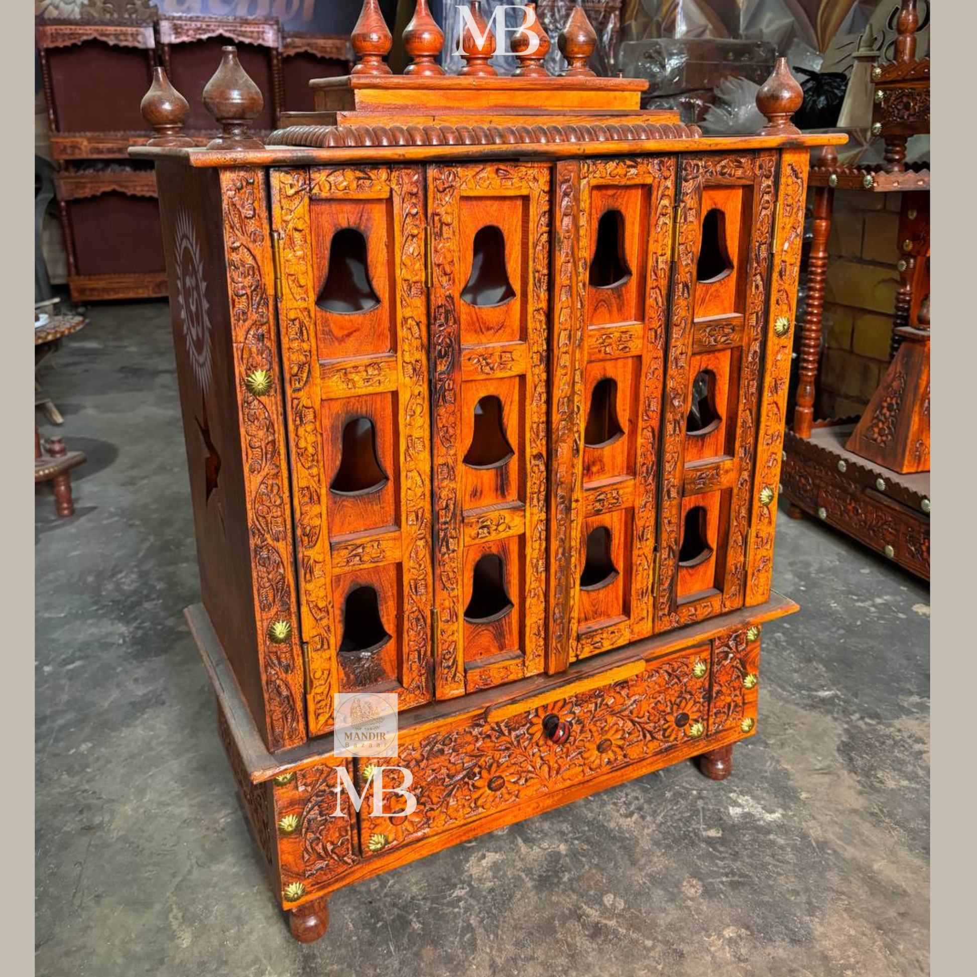 Traditional wooden pooja mandir with carved panels and decorative top