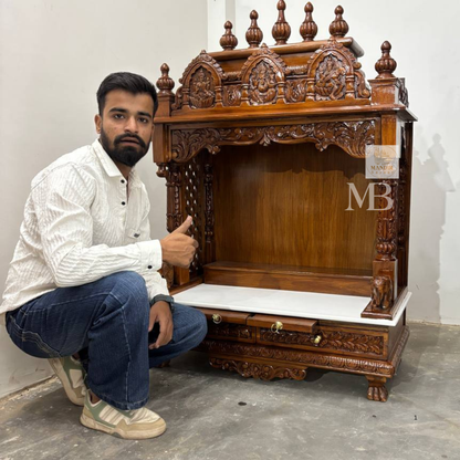 Handcrafted wooden pooja mandir for home with carved deities and marble platform