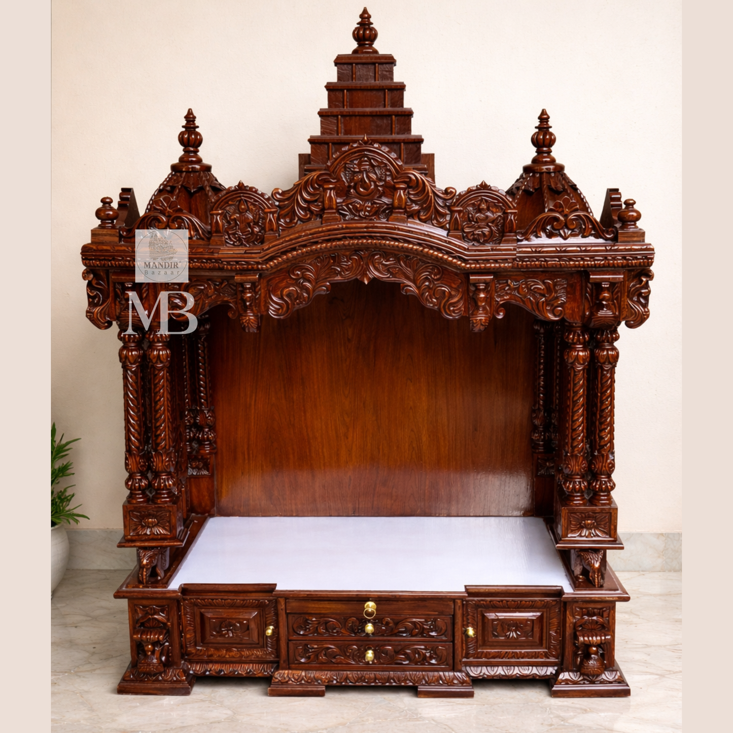 Hand carved wooden pooja mandir with traditional crown, Ganesha carving, ornate pillars, marble-look platform and storage drawers