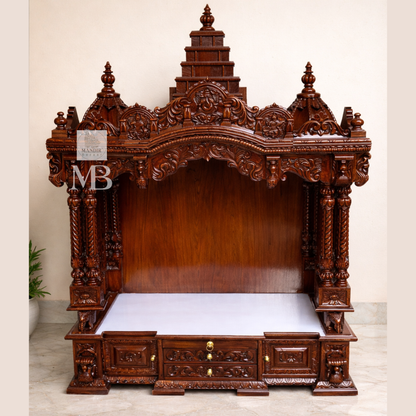 Hand carved wooden pooja mandir with traditional crown, Ganesha carving, ornate pillars, marble-look platform and storage drawers