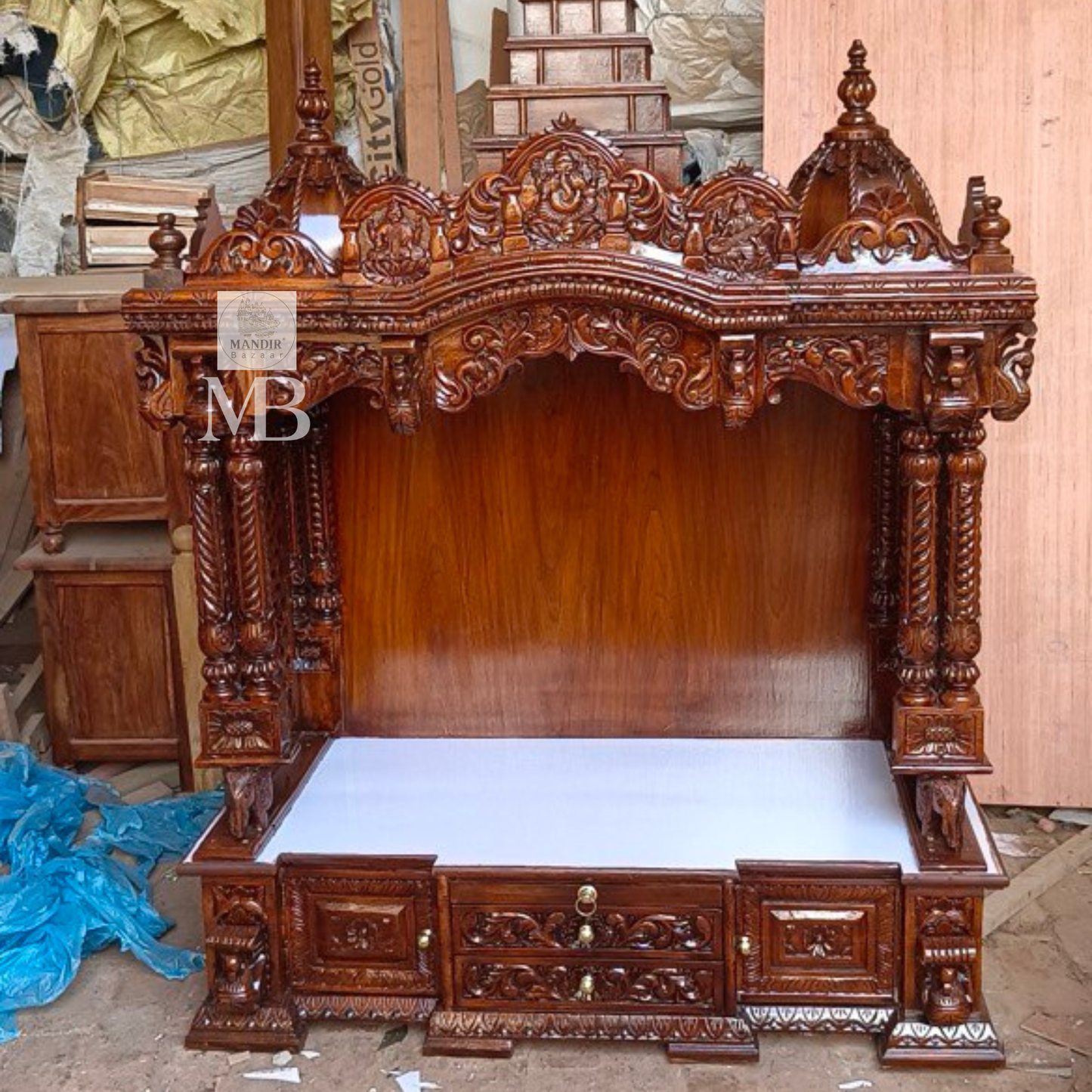 Hand carved wooden pooja mandir with traditional crown, Ganesha carving, ornate pillars, marble-look platform and storage drawers
