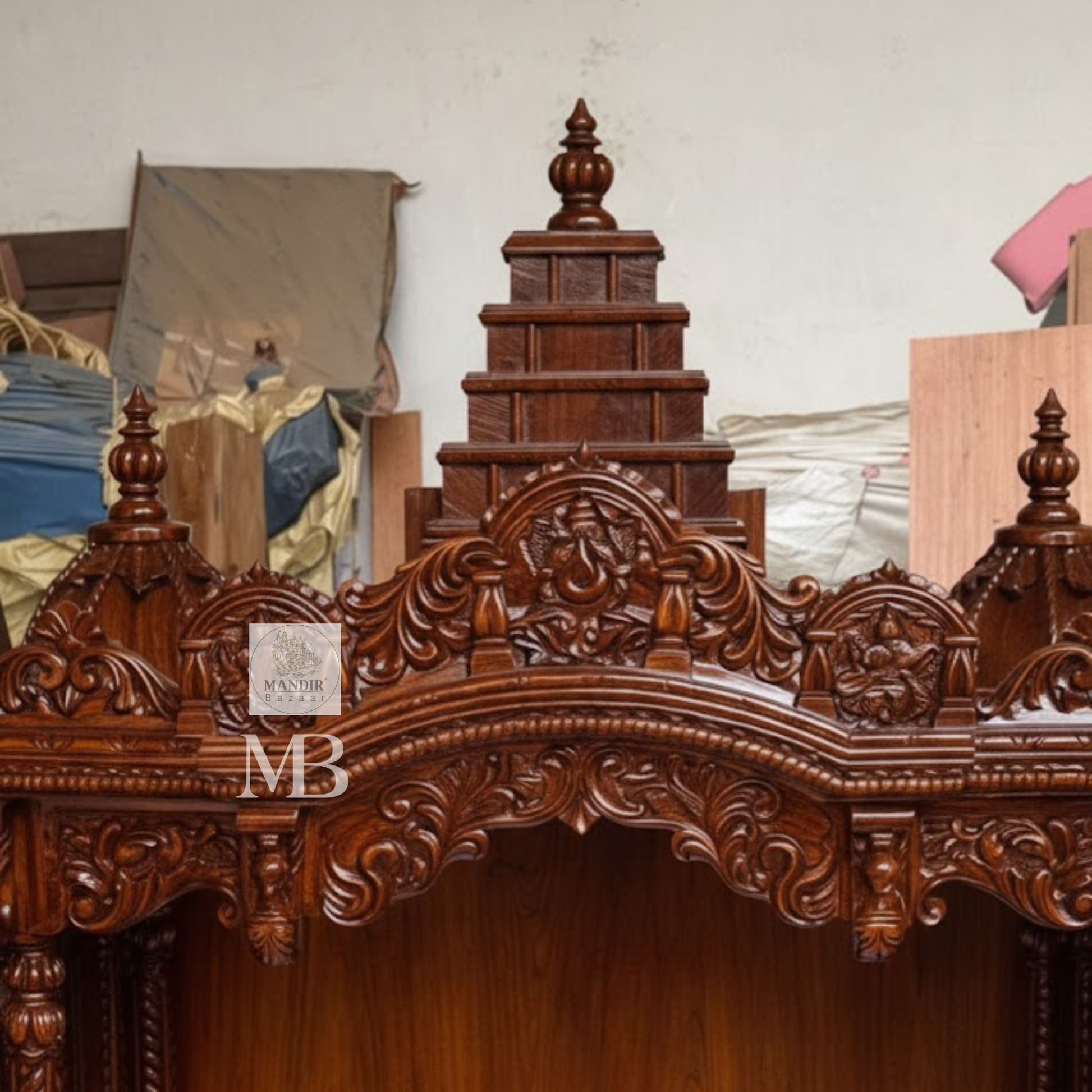 
Hand carved wooden pooja mandir with traditional crown, Ganesha carving, ornate pillars, marble-look platform and storage drawers
