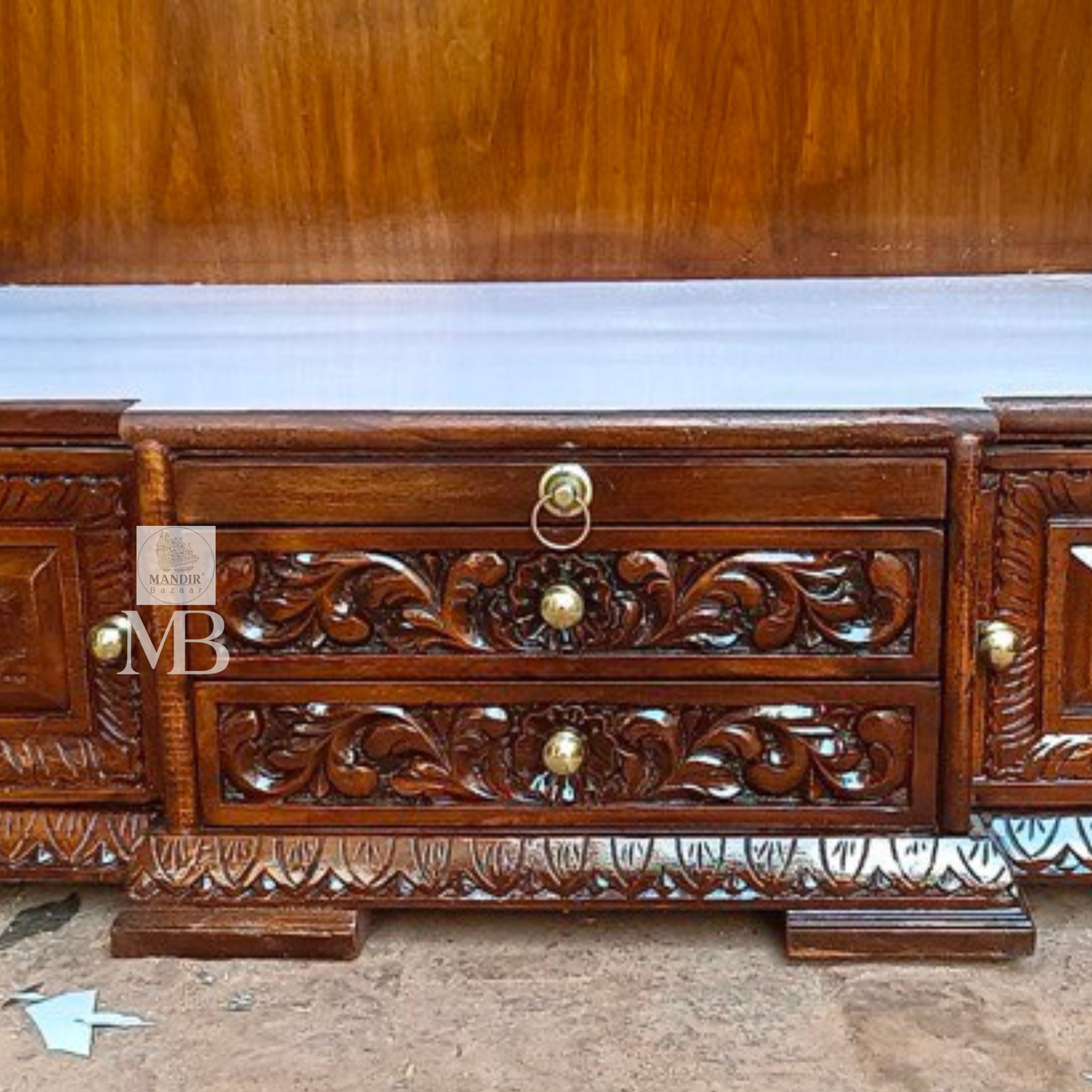 Hand carved wooden pooja mandir with traditional crown, Ganesha carving, ornate pillars, marble-look platform and storage drawers
