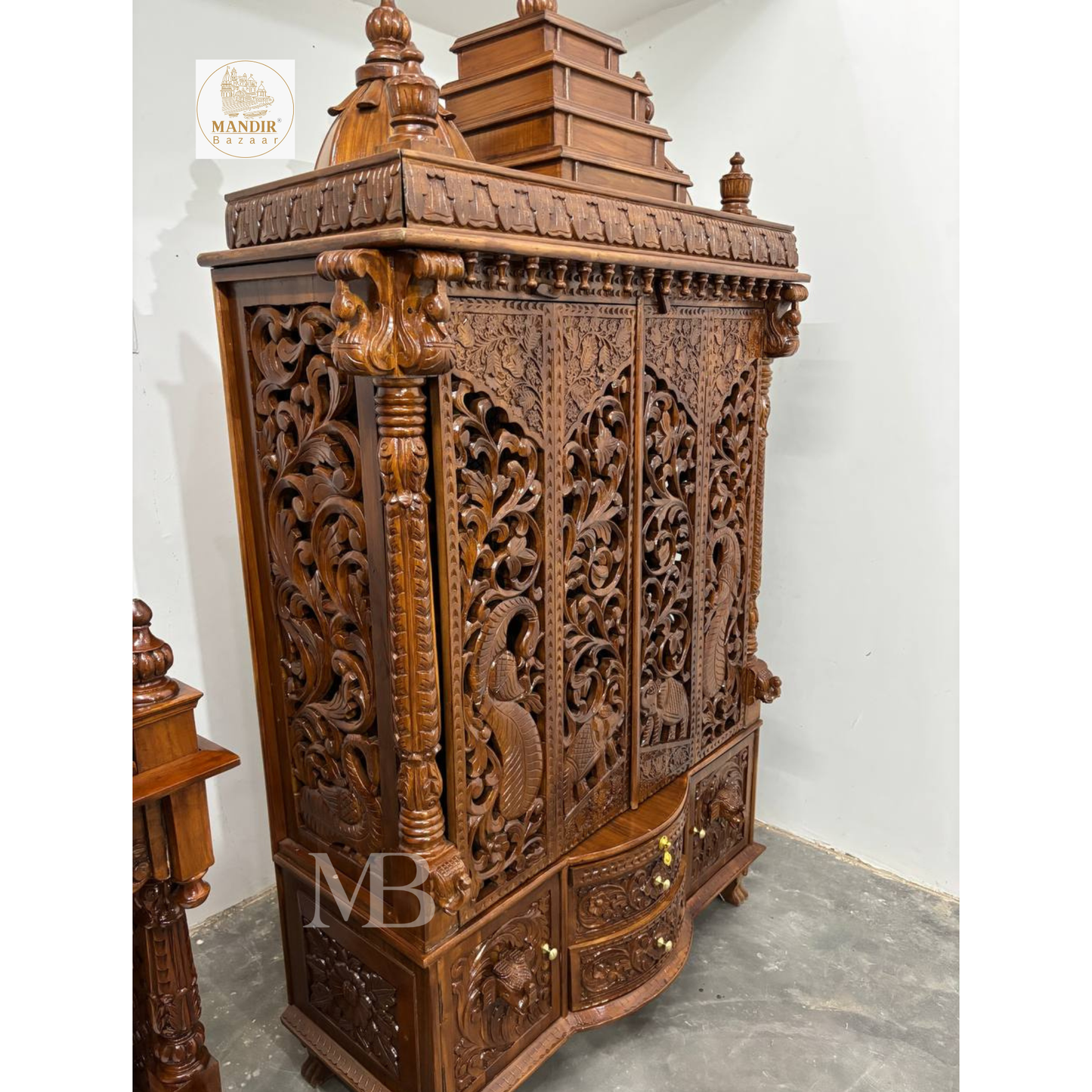Traditional wooden pooja mandir with intricate jaali door panels