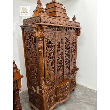 Traditional wooden pooja mandir with intricate jaali door panels